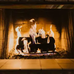 Un feu de cheminée crépite joyeusement, ses flammes dansantes illuminent les briques et les bûches. Les signes d'un hiver douillet.