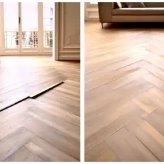 Un beau parquet en chevrons montre des signes de gondolage, avec des lames qui se soulèvent et créent des espaces.